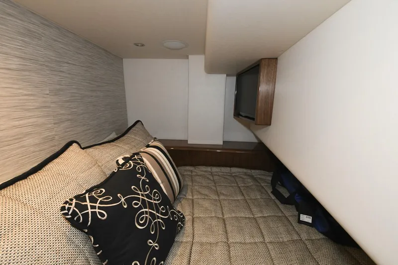 Slide: The Image of Interior cabin of 2022 Viking 44 Sport Coupe with cozy bedding and TV. - 21