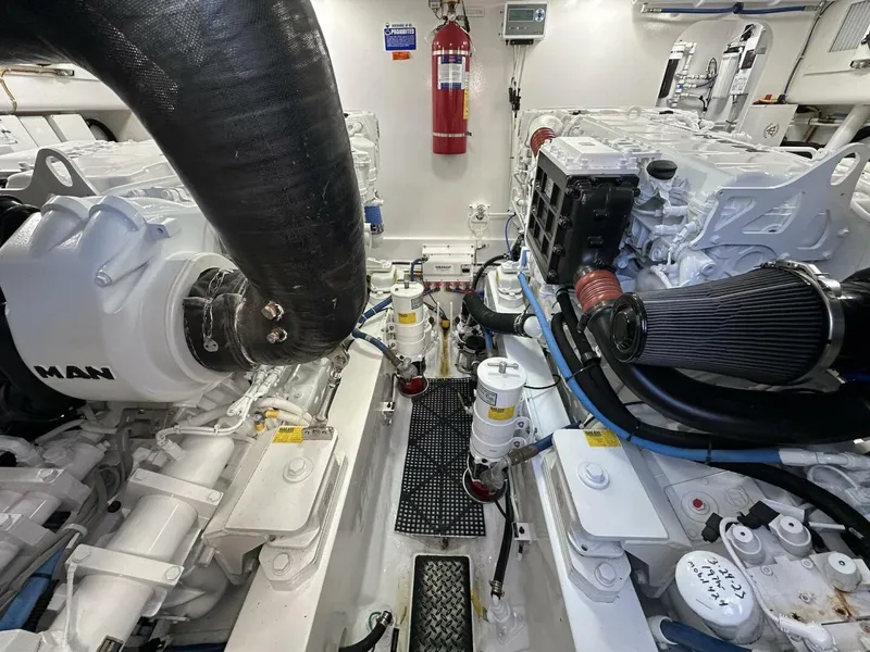 Slide: The Image of Engine room of a 2022 Viking 44 Sport Coupe, showcasing dual engines and equipment. - 38