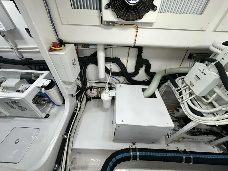 Slide: The Image of Engine room of 2022 Viking 44 Sport Coupe, showcasing complex wiring and mechanical components. - 45
