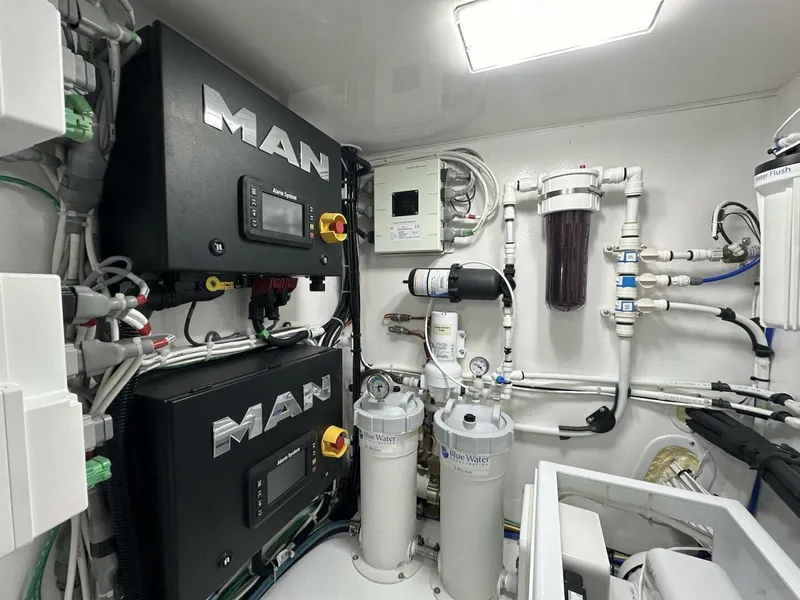 Slide: The Image of Engine room of 2022 Viking 44 Sport Coupe with MAN systems and filtration units. - 49