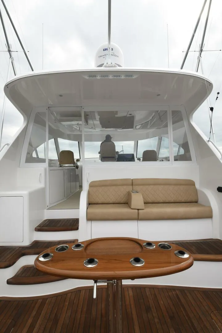 Slide: The Image of 2022 Viking 44 Sport Coupe yacht with sleek design and luxurious seating area. - 7