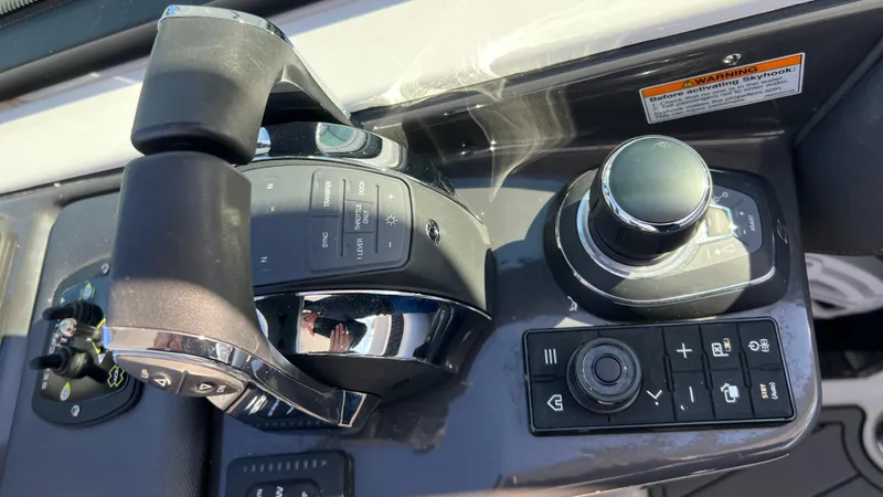 Slide: The Image of 2021 Monterey 385 SE boat control panel with throttle and joystick. - 11