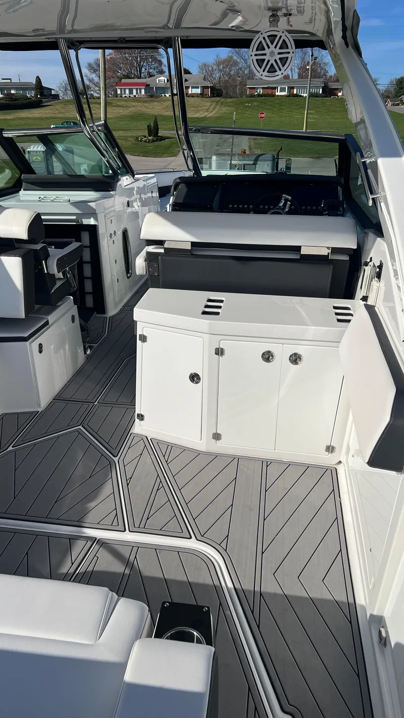 Slide: The Image of 2021 Monterey 385 SE boat interior with modern seating and sleek design. - 14