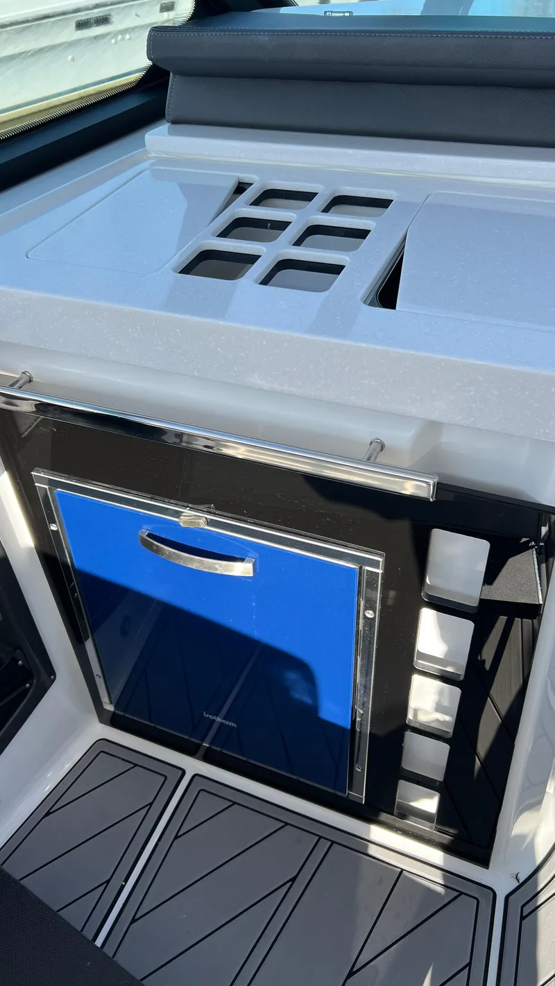 Slide: The Image of 2021 Monterey 385 SE boat interior with sleek countertop and storage compartment. - 19