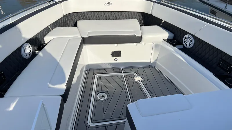 Slide: The Image of 2021 Monterey 385 SE boat interior with cushioned seating and sleek flooring. - 21
