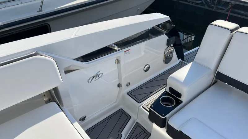 Slide: The Image of 2021 Monterey 385 SE boat interior with white seating and cup holder. - 24