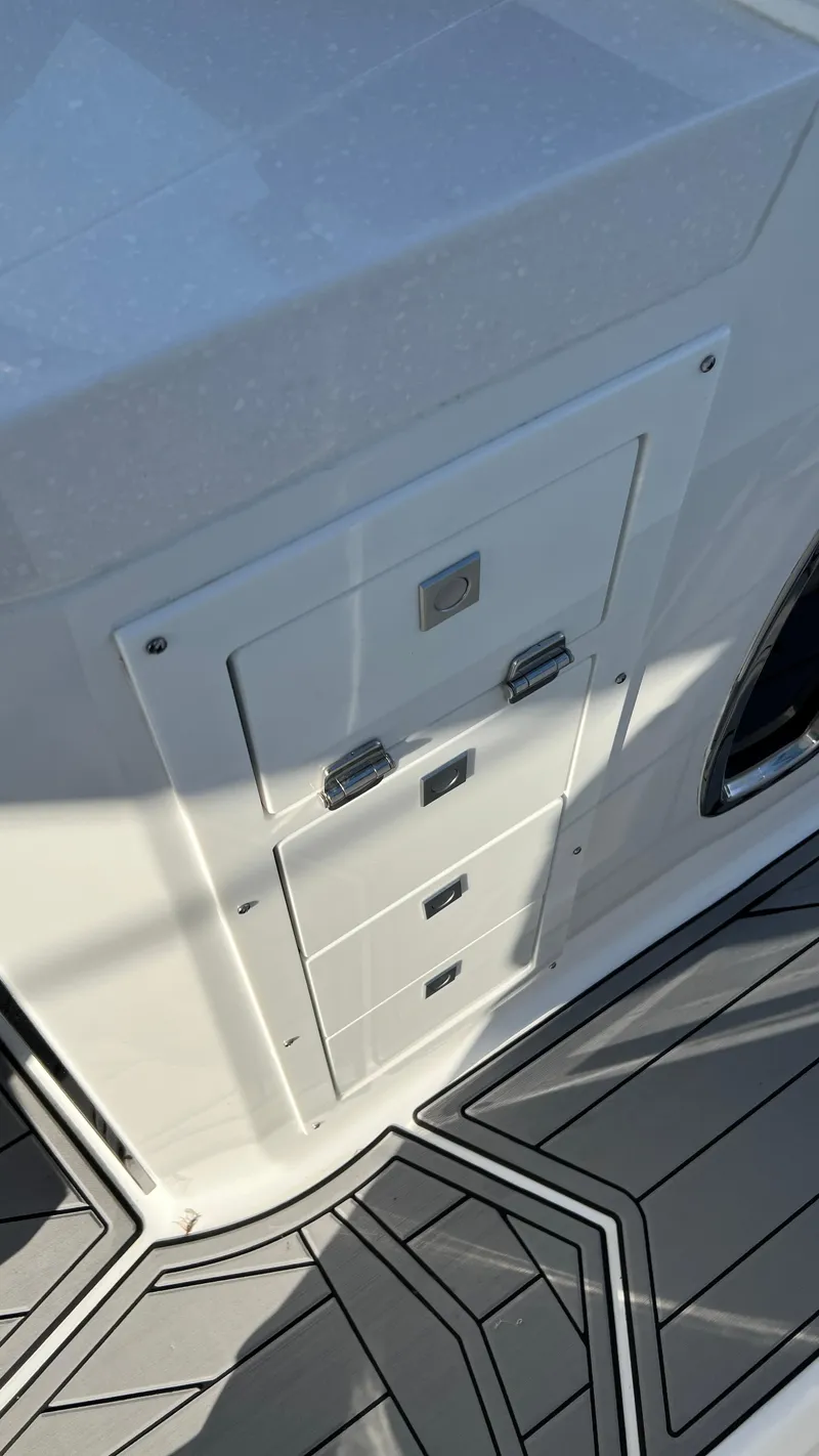 Slide: The Image of 2021 Monterey 385 SE boat interior with storage compartments and sleek flooring design. - 25