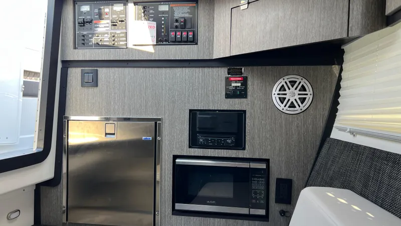 Slide: The Image of 2021 Monterey 385 SE interior with control panel, microwave, and speaker. - 27