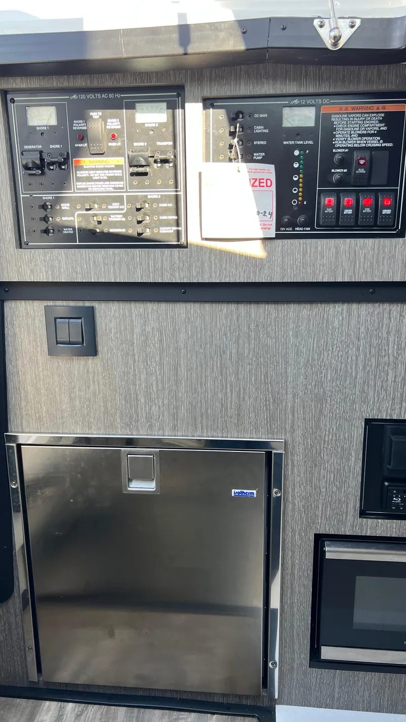Slide: The Image of Control panel and appliances on a 2021 Monterey 385 SE boat interior. - 28