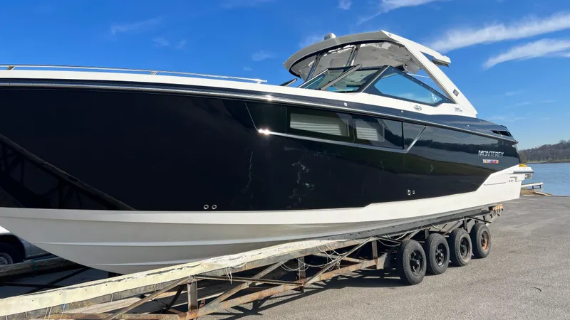 Slide: The Image of 2021 Monterey 385 SE boat on trailer under clear blue sky. - 3