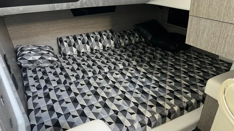 Slide: The Image of 2021 Monterey 385 SE cabin interior with geometric-patterned bedding. - 31