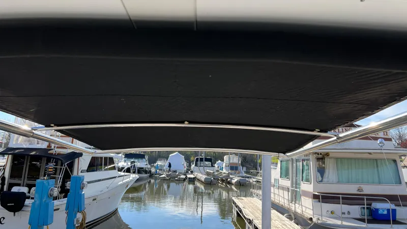 Slide: The Image of 2021 Monterey 385 SE boat docked at marina with canopy view. - 35