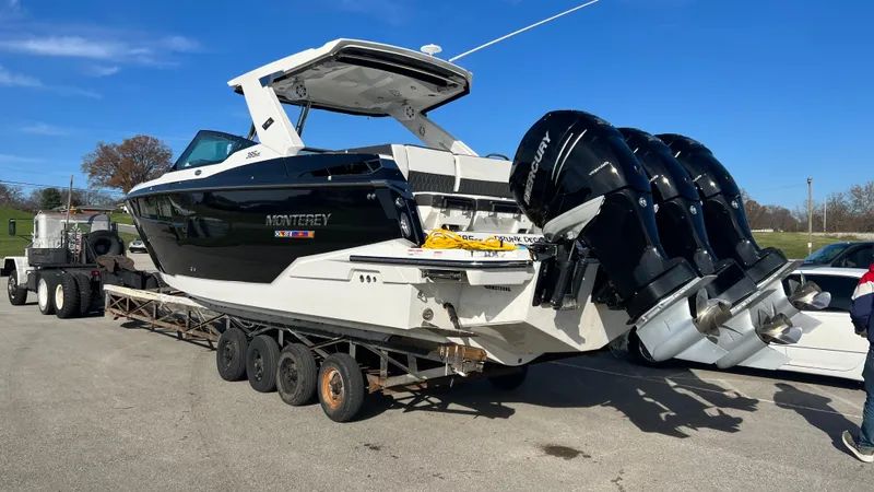 Slide: The Image of 2021 Monterey 385 SE boat on trailer with triple Mercury outboard engines. - 4