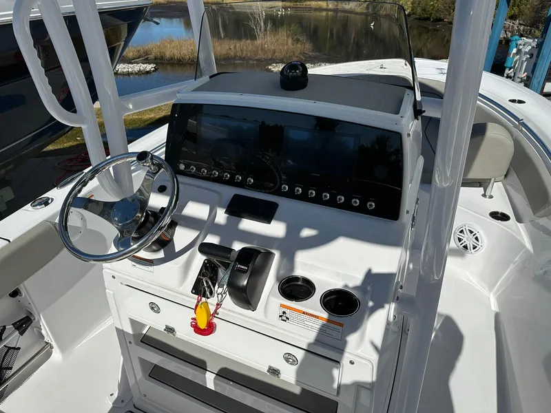 Slide: The Image of 2023 Sportsman Open 212 Center Console boat interior with steering wheel and control panel. - 11