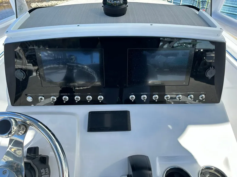 Slide: The Image of 2023 Sportsman Open 212 Center Console dashboard with dual screens and controls. - 12