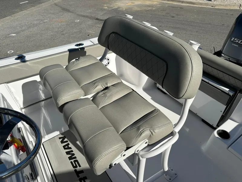 Slide: The Image of 2023 Sportsman Open 212 Center Console boat seat, gray upholstery, marine setting. - 21
