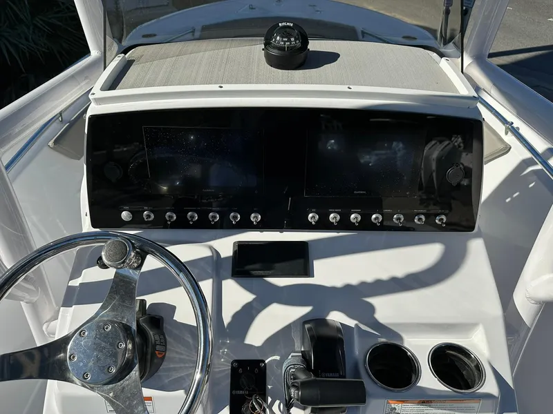 Slide: The Image of 2023 Sportsman Open 212 Center Console dashboard with steering wheel and controls. - 23