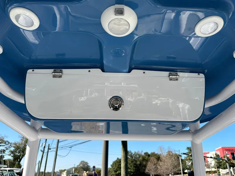 Slide: The Image of 2023 Sportsman Open 212 Center Console boat's overhead storage compartment and lighting. - 24