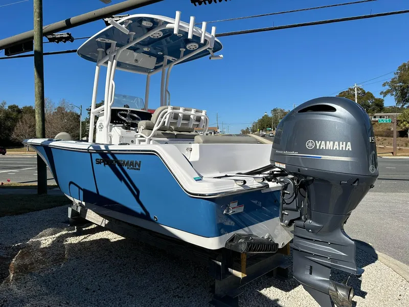 Slide: The Image of 2023 Sportsman Open 212 Center Console boat with Yamaha engine, parked outdoors. - 3