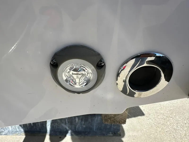 Slide: The Image of 2023 Sportsman Open 212 Center Console boat detail with light and chrome exhaust. - 6