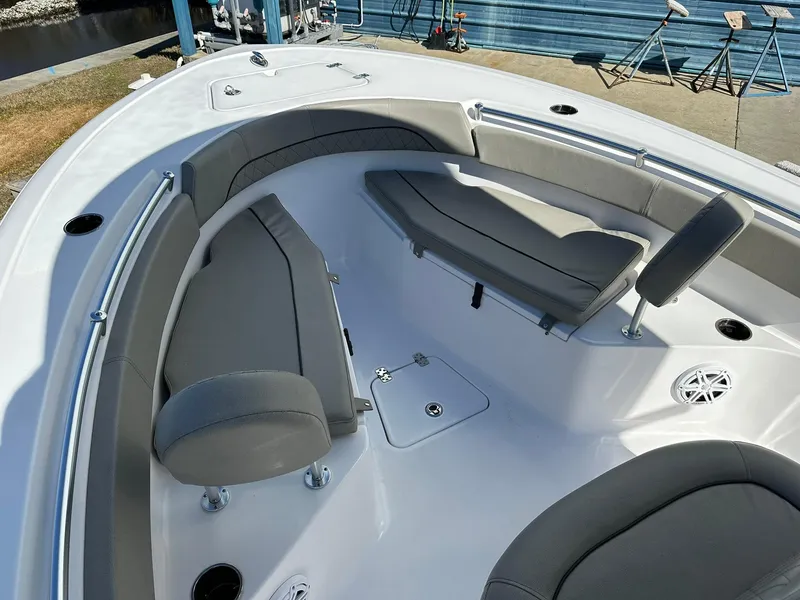 Slide: The Image of 2023 Sportsman Open 212 Center Console boat interior with gray seating and storage compartments. - 7