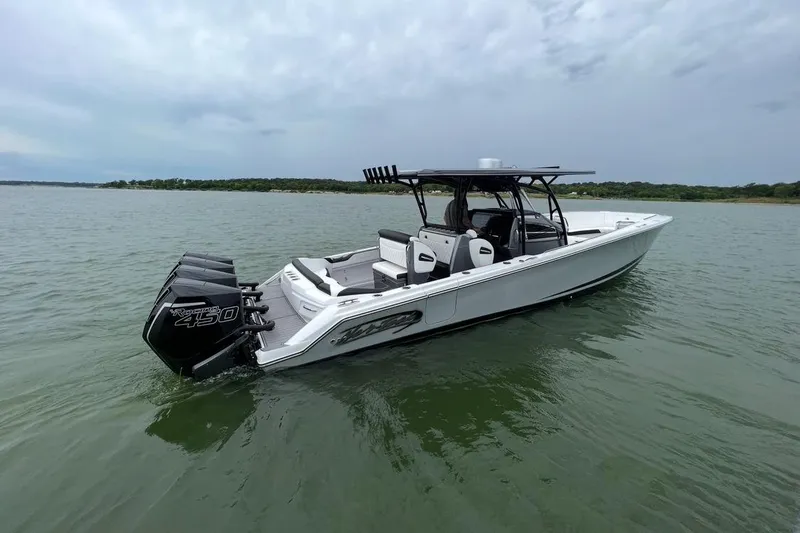 The Image of 2022 Nor-Tech 390 Center Console boat on calm water, featuring powerful outboard engines. - 0