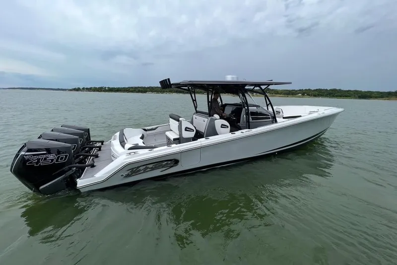Slide: The Image of 2022 Nor-Tech 390 Center Console boat on calm water, featuring powerful engines. - 1