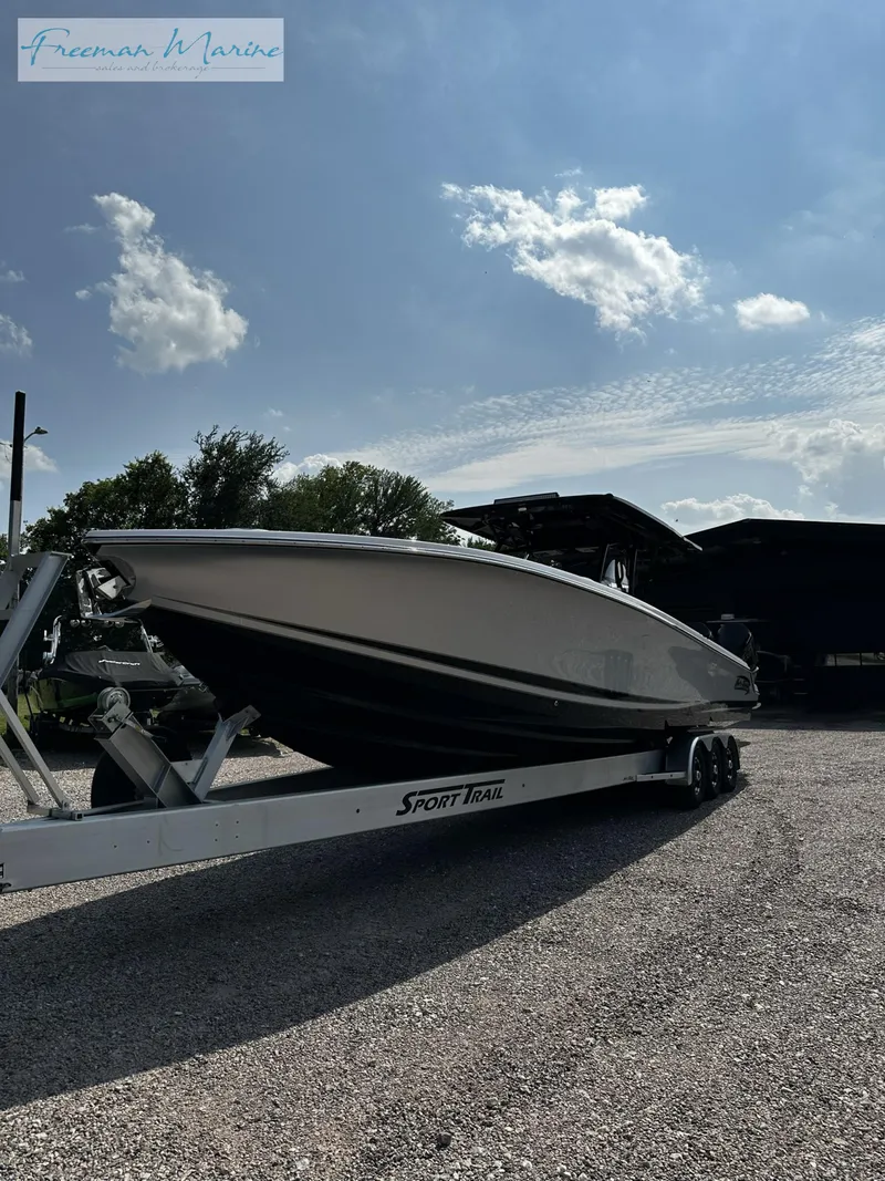 Slide: The Image of 2022 Nor-Tech 390 Center Console boat on a Sport Trail trailer under a sunny sky. - 12