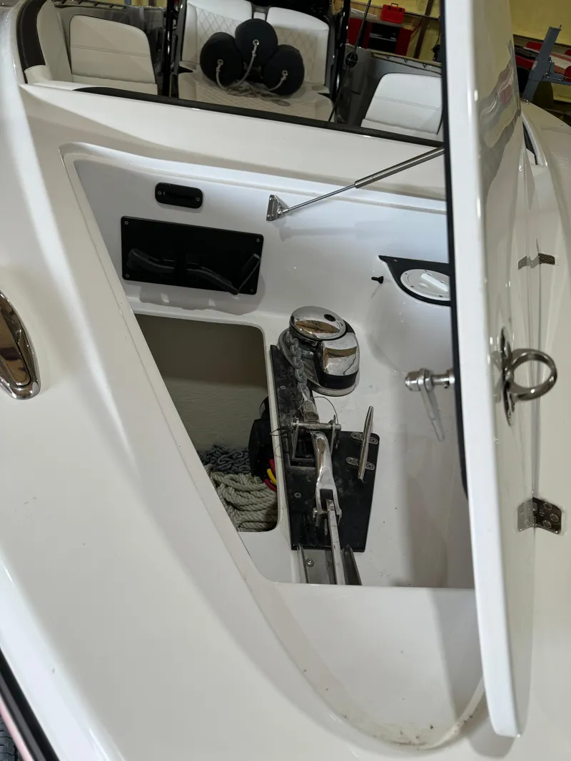 Slide: The Image of 2022 Nor-Tech 390 Center Console anchor storage compartment with open hatch. - 16