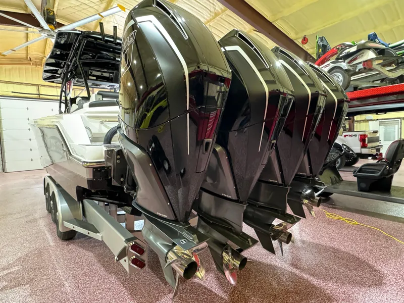 Slide: The Image of 2022 Nor-Tech 390 Center Console with quad outboard engines in a showroom. - 18