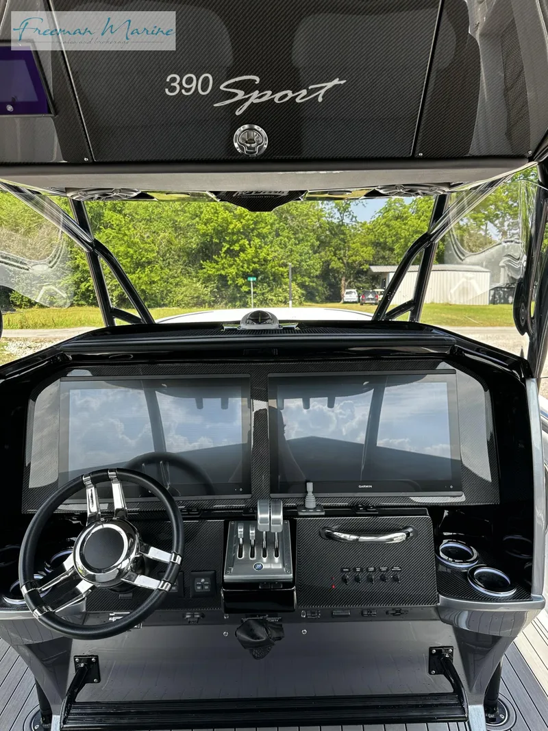 Slide: The Image of 2022 Nor-Tech 390 Center Console boat dashboard with steering wheel and controls. - 7