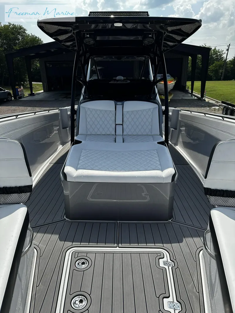 Slide: The Image of 2022 Nor-Tech 390 Center Console boat with luxurious seating and sleek design. - 8
