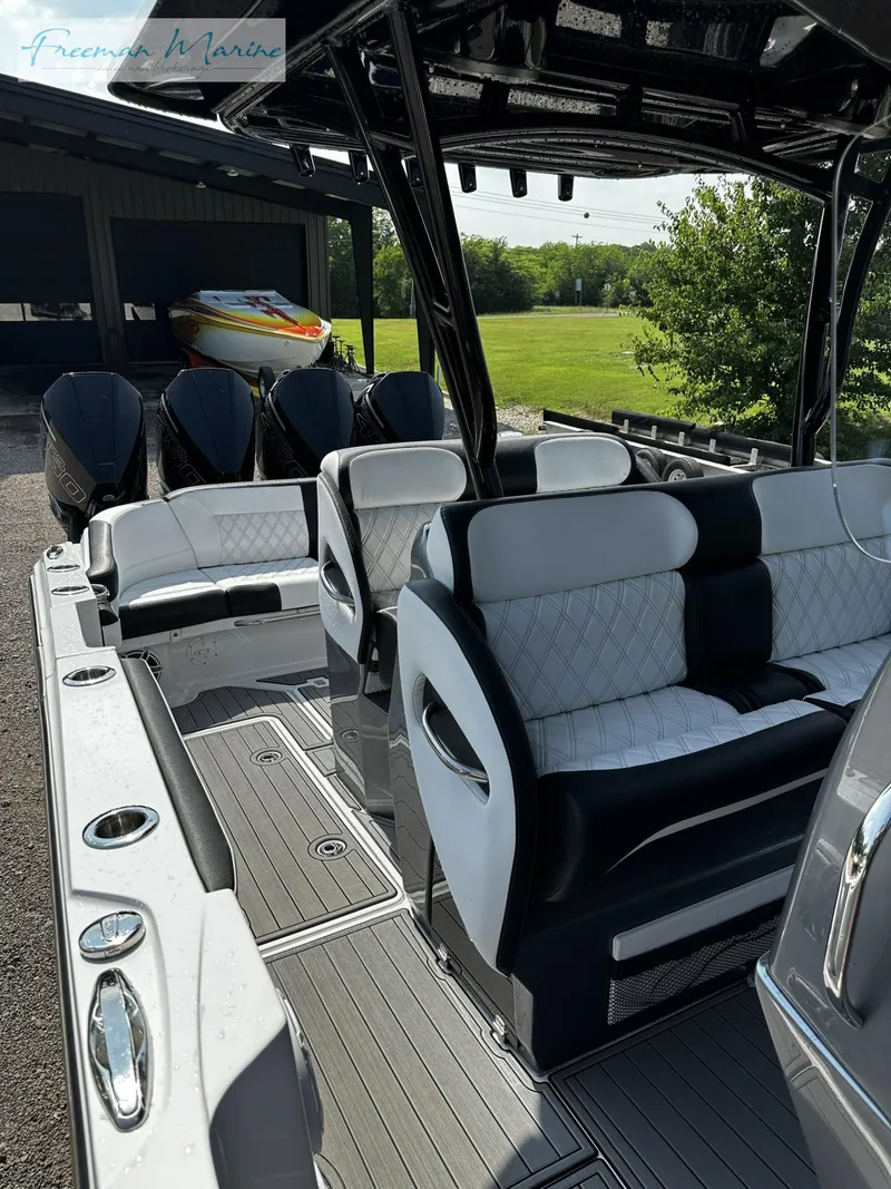 Slide: The Image of 2022 Nor-Tech 390 Center Console boat with luxurious seating and sleek design. - 9