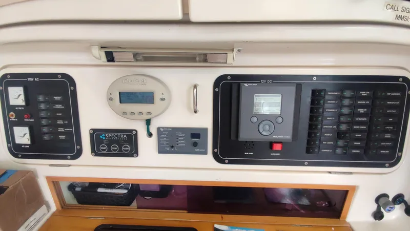 Slide: The Image of Control panel of a 2002 Voyage 440 yacht with various gauges and switches. - 10