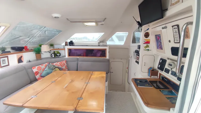 Slide: The Image of Interior of 2002 Voyage 440 yacht with cozy seating and navigation controls. - 11