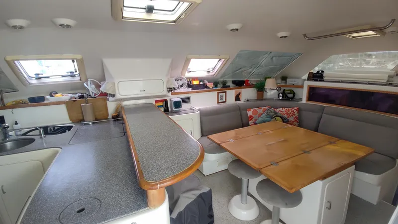 Slide: The Image of Interior of 2002 Voyage 440 catamaran with kitchen and dining area. - 12