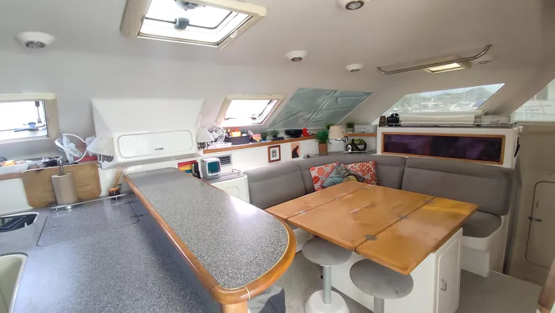 Slide: The Image of Interior of 2002 Voyage 440 yacht with dining area and modern kitchen. - 13