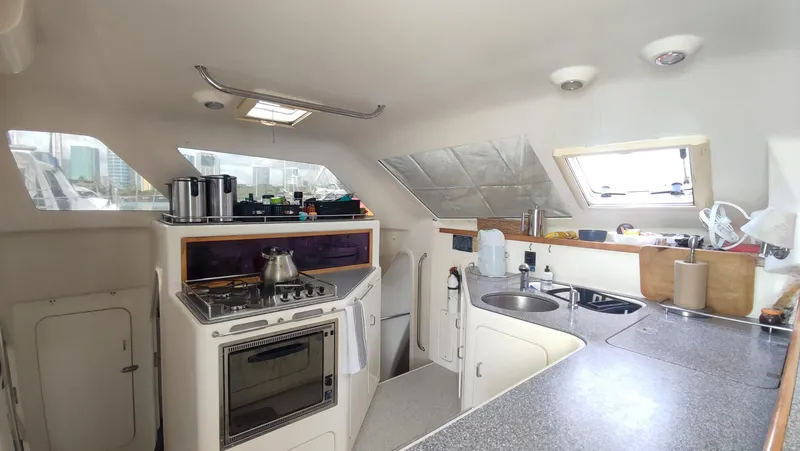 Slide: The Image of Interior of 2002 Voyage 440 yacht kitchen with stove, sink, and countertop. - 15