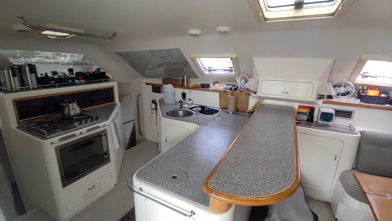 Slide: The Image of Interior of 2002 Voyage 440 yacht kitchen with stove, sink, and counter space. - 17