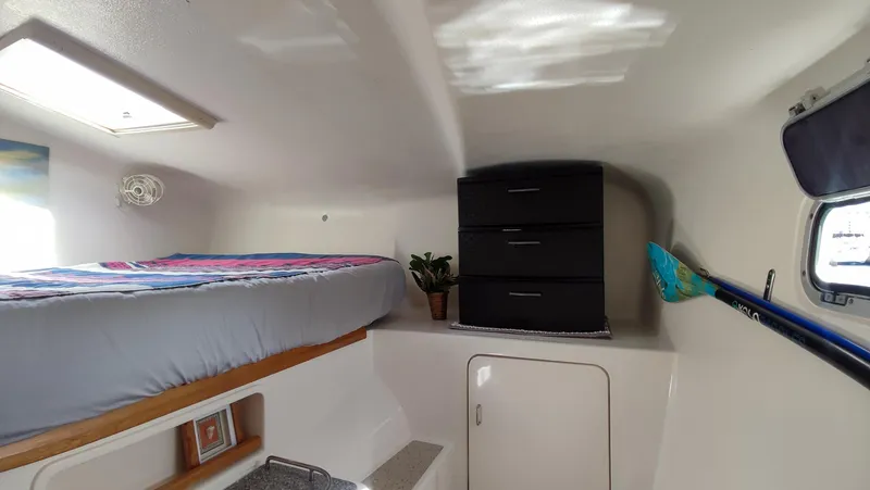 Slide: The Image of Cozy cabin interior of 2002 Voyage 440 yacht with bed, storage, and window. - 18