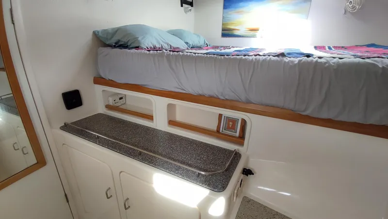 Slide: The Image of Interior cabin of 2002 Voyage 440 yacht with bed and storage. - 19