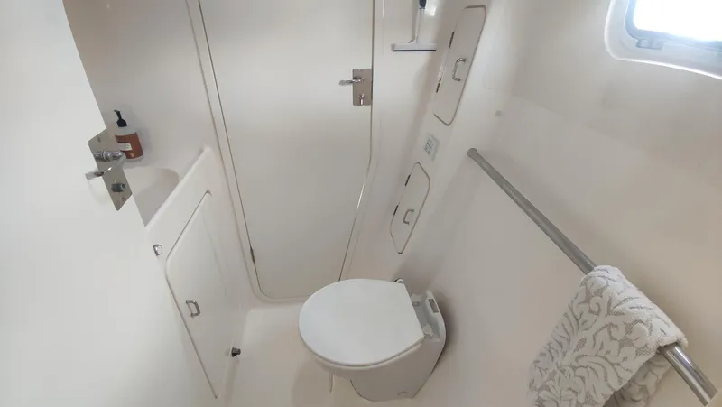 Slide: The Image of Compact bathroom in 2002 Voyage 440 yacht with toilet, sink, and towel rack. - 25