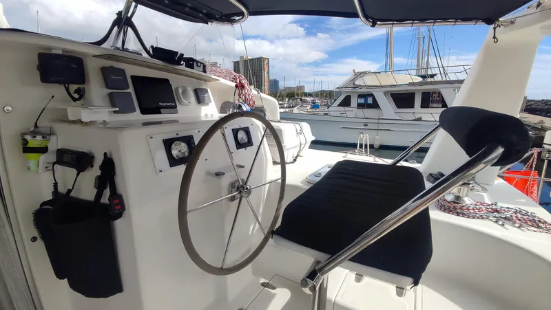 Slide: The Image of Voyage 440 yacht cockpit, 2002 model, featuring steering wheel and navigation equipment at marina. - 5