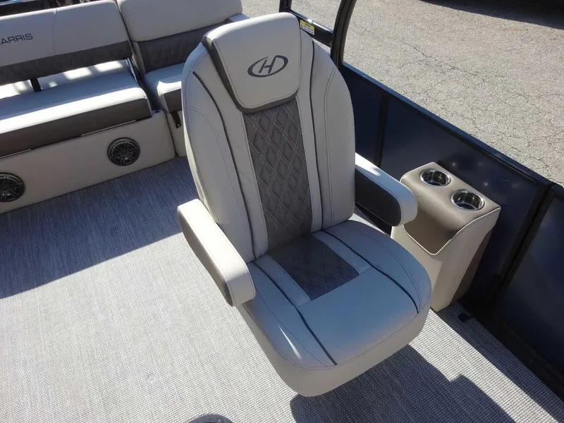 Slide: The Image of 2024 Harris Sunliner 230 Sport boat interior with luxurious seating and cup holders. - 11