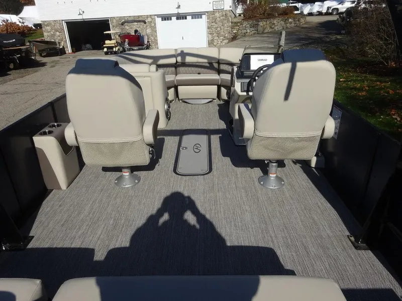 Slide: The Image of 2024 Harris Sunliner 230 Sport interior with beige seating and modern dashboard. - 17