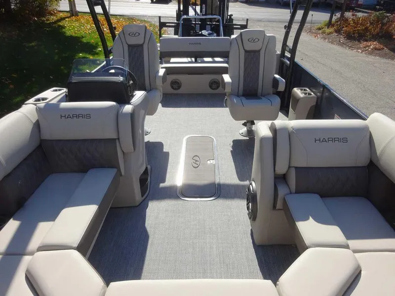 Slide: The Image of 2024 Harris Sunliner 230 Sport pontoon boat interior with plush seating and modern design. - 7