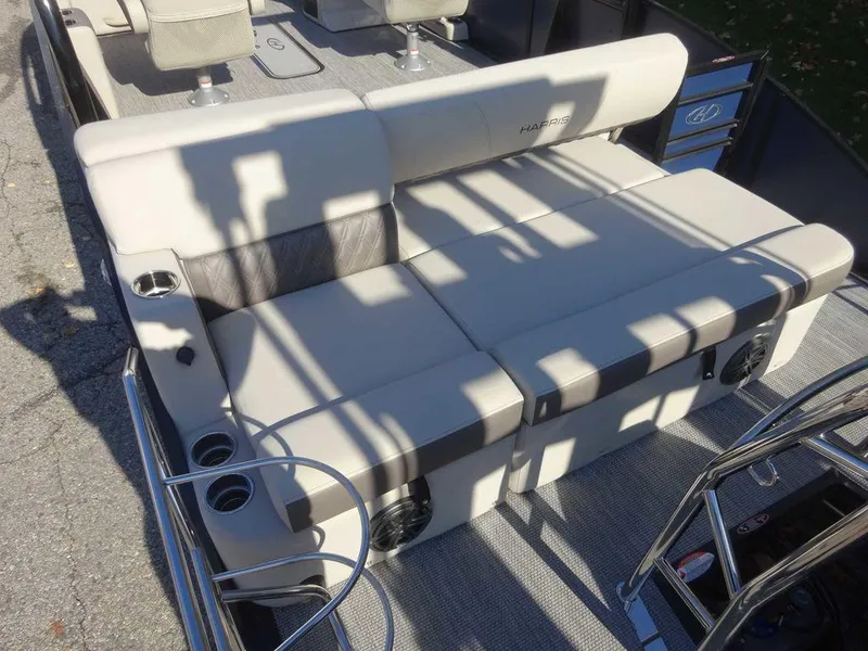 Slide: The Image of 2024 Harris Sunliner 230 Sport boat seating area with cup holders and modern design. - 8