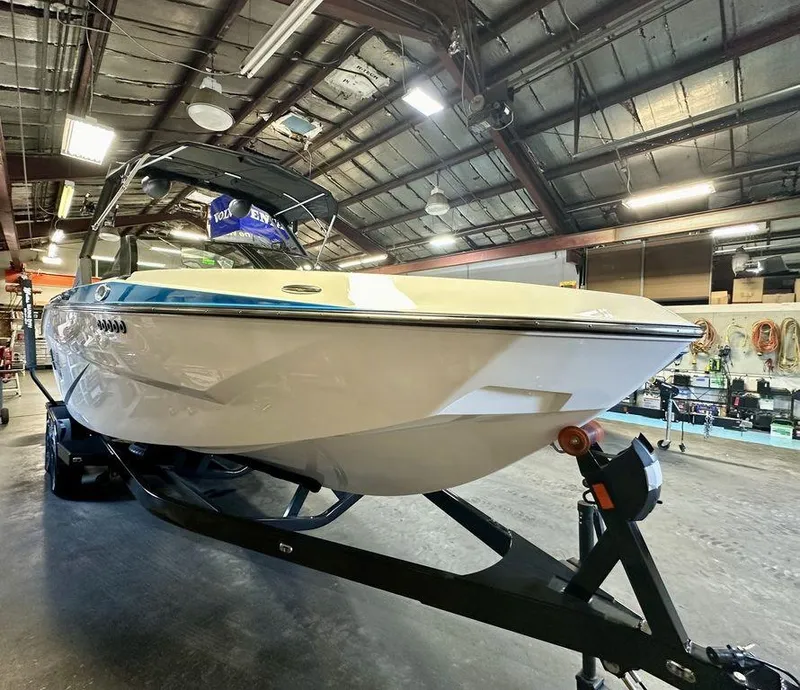 Slide: The Image of 2024 Axis T250 boat in a workshop, showcasing sleek design and modern features. - 13