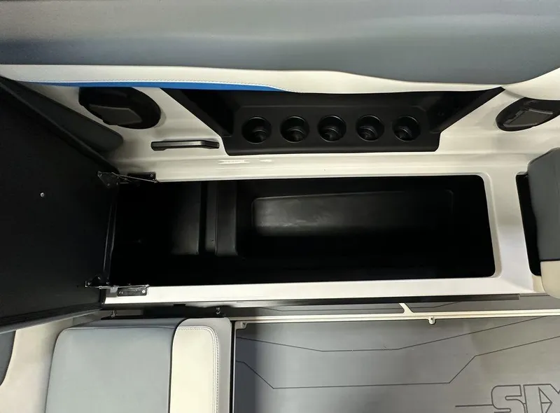 Slide: The Image of 2024 Axis T250 boat interior storage compartment with cup holders and seating. - 14