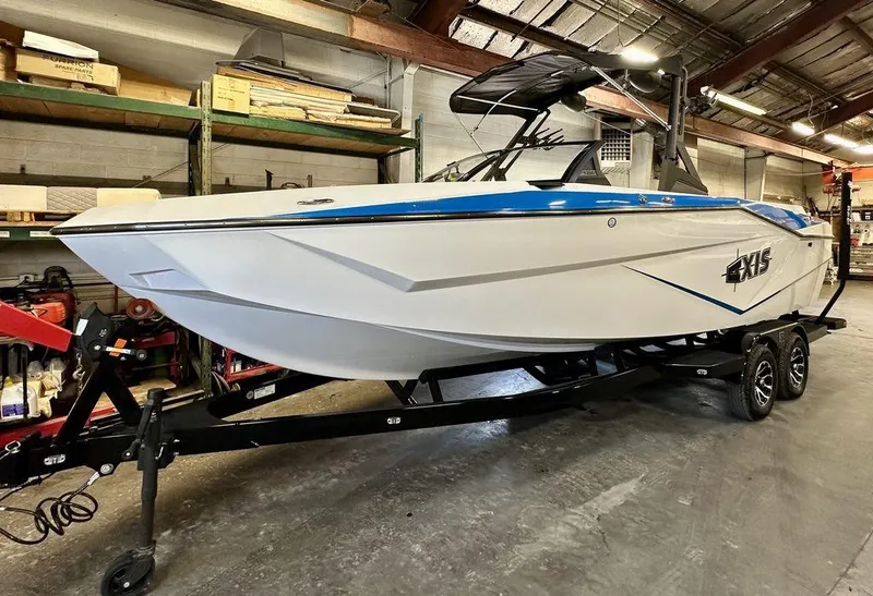 Slide: The Image of 2024 Axis T250 boat on trailer in warehouse setting. - 19